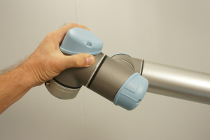 universal-robots-zacobria-hold-robot-teach-pendant-press-button-move